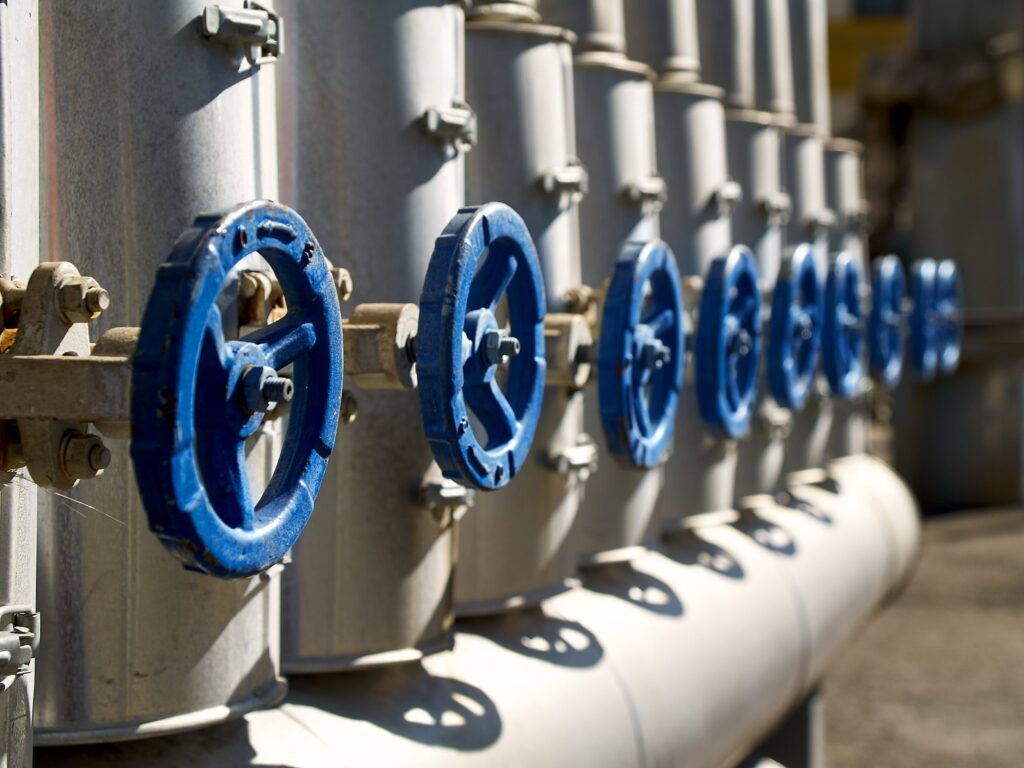 Industrial valves in a row on petrochemical plant pipelines system