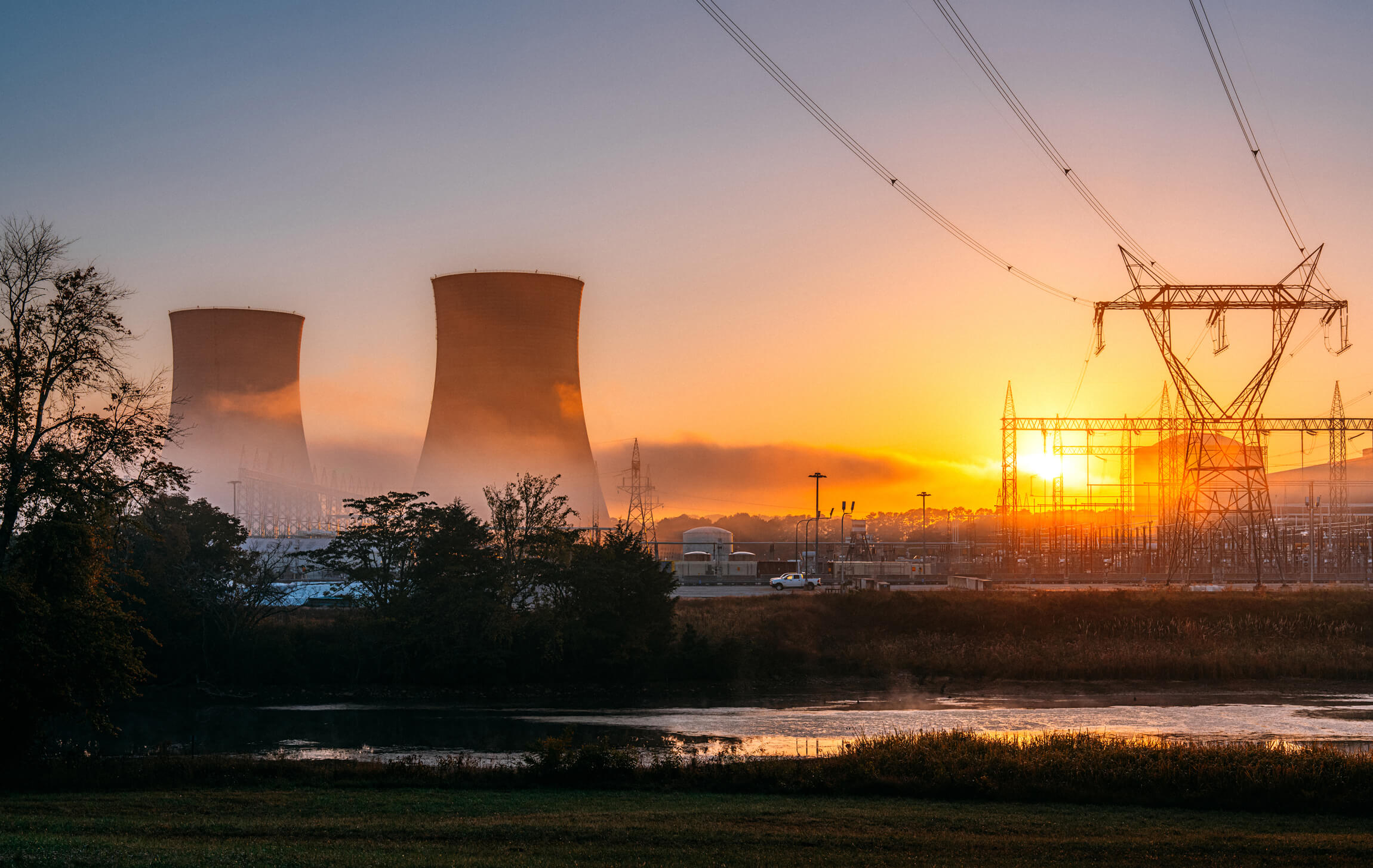 Nuclear Power plant in front of a river at sunrise