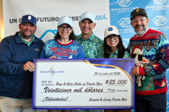 A group of people holding a check for $25,000 for the Boys & Girls Clubs of Puerto Rico.