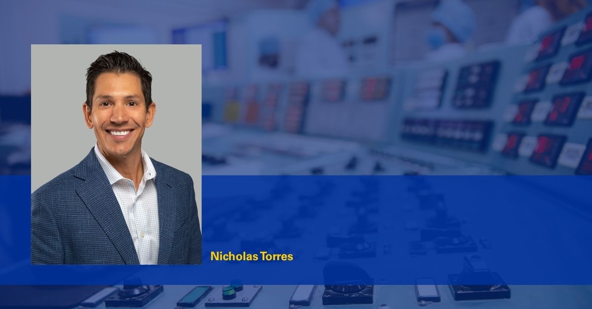 Photo of Nicholas Torres with blurred background of a nuclear power plant control room.